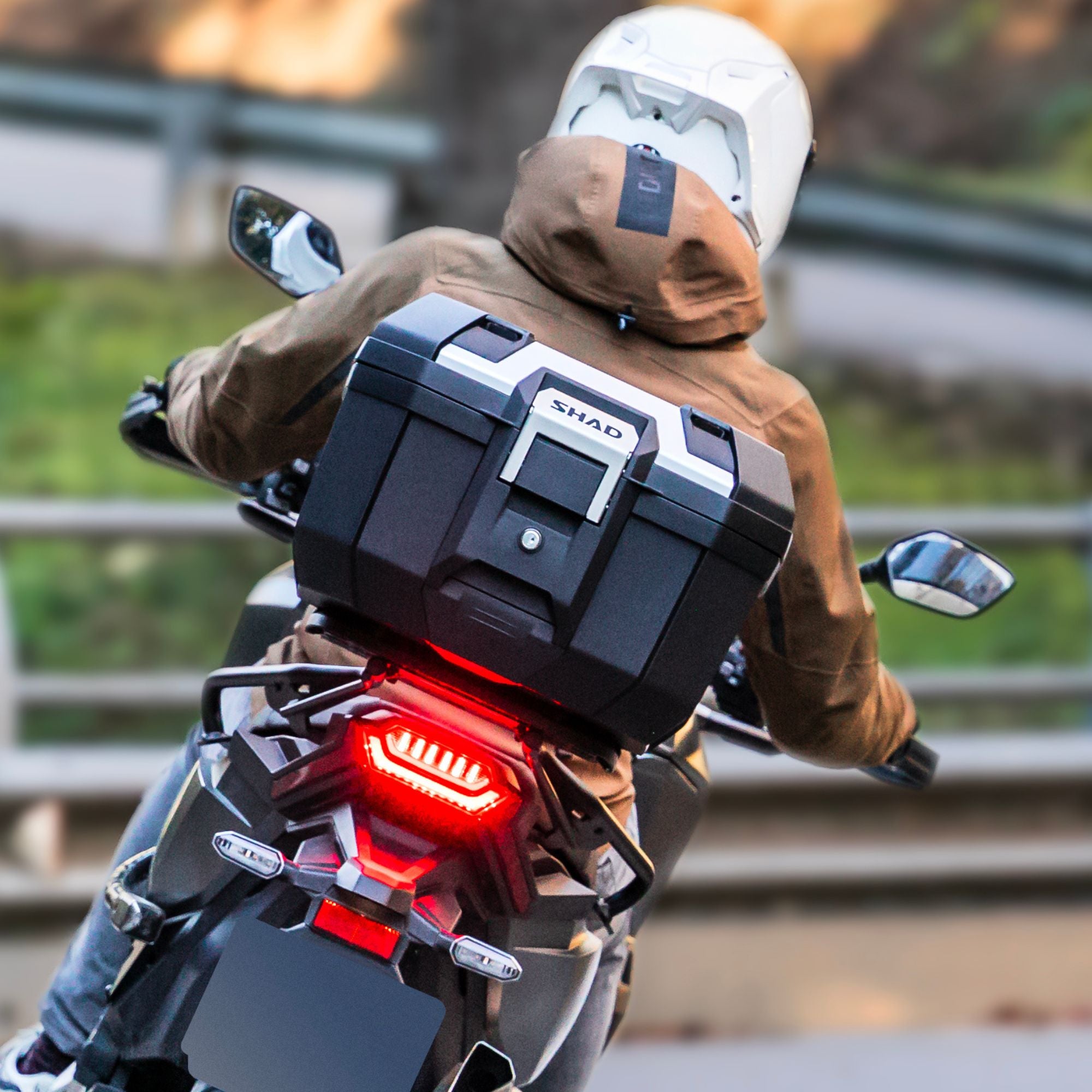 motorcyclist riding motorcycle with SHAD TR41 top box luggage mounted